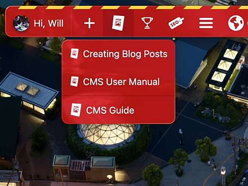 A screenshot of a webpage with a red navigation bar featuring options like 'Creating Blog Posts' and 'CMS User Manual' against an aerial view of a cityscape.